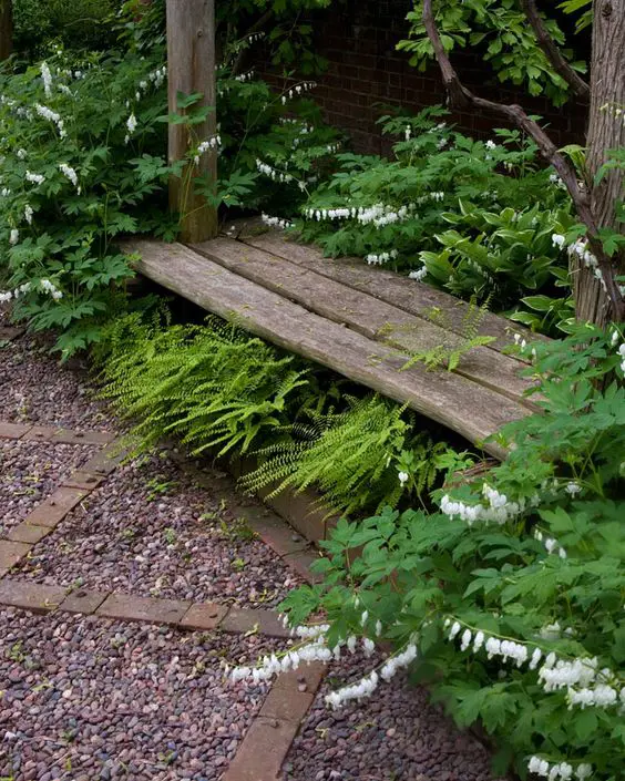 White garden with a bench seat